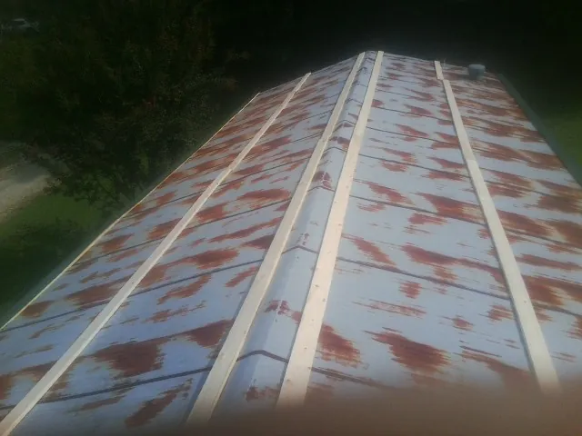 Rusted metal roof panels with new wood purlins before replacement — Storm Damage Roof Repair in Juntura by Roofing Brothers